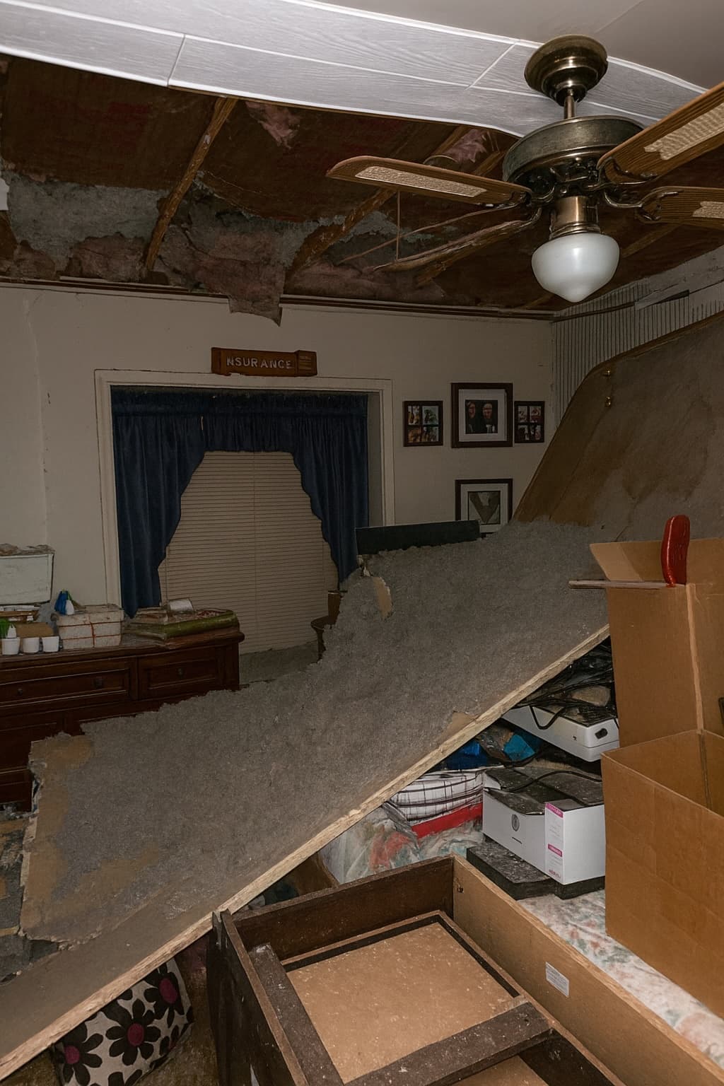 Storm-damaged ceiling and insulation collapse from interior water intrusion.