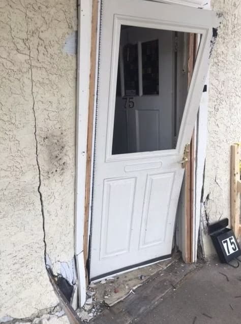 Exterior structural damage from storm impact.